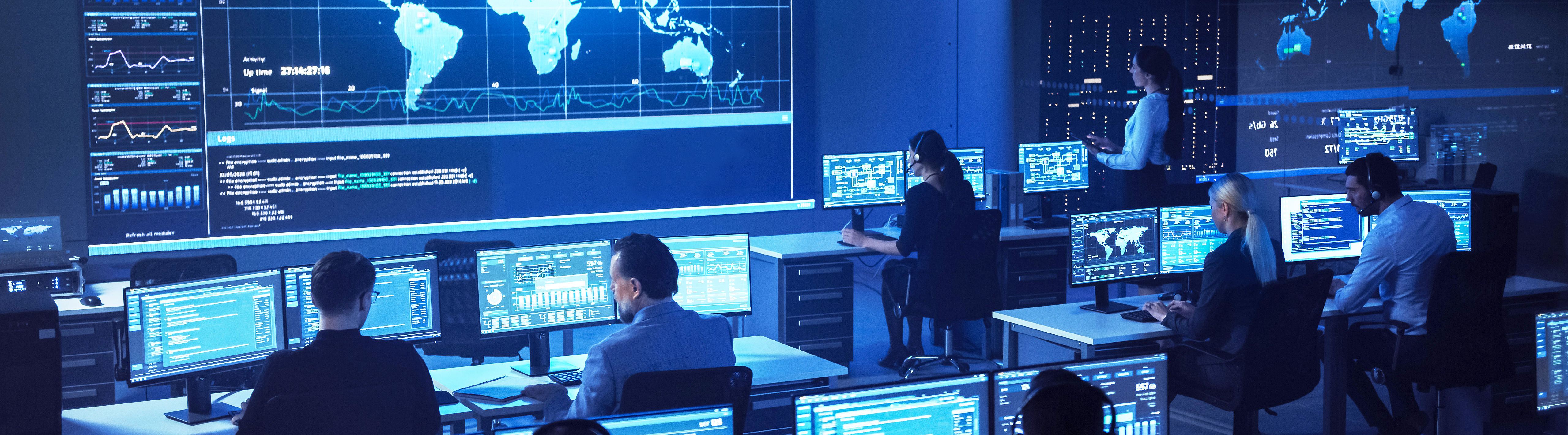Control center with big screen and six people working at computers