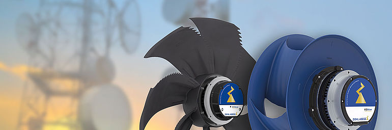 black axial fan FE2owlet ECblue and blue centrifugal fan ZAbluefin with transmission tower in the background