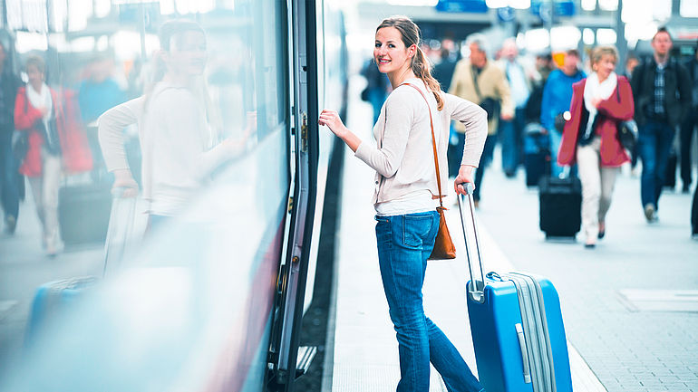 train with female passenger in railroad station