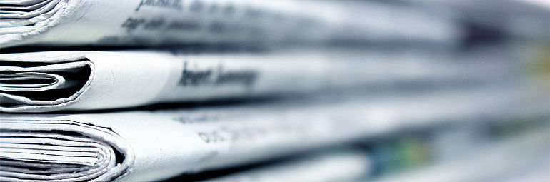 Teaser Press Newspapers stacked on top of each other