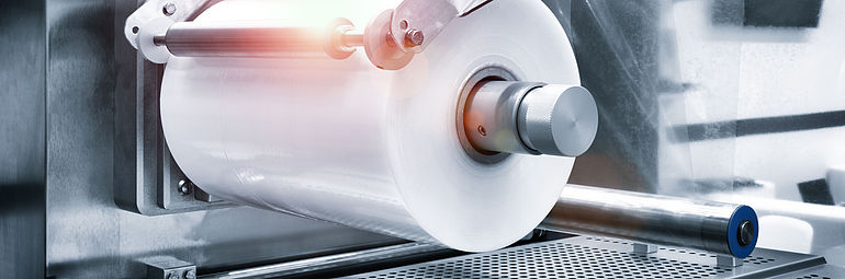 2_packaging and production machine Detail view roll with plastic film in packaging machine