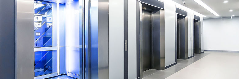 elevators with blue light in a row