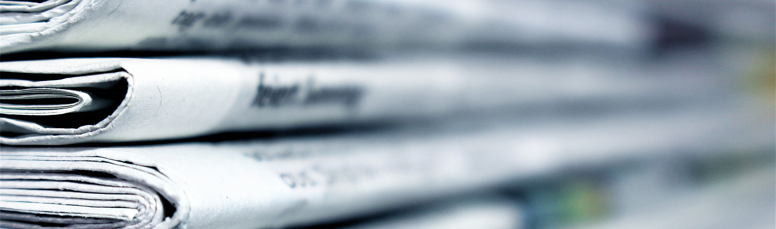 Press_Header Newspapers stacked on each other