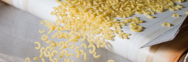 dry noodles on a conveyor belt