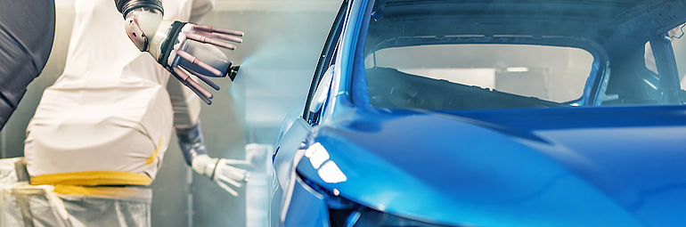 Robot painting car body blue