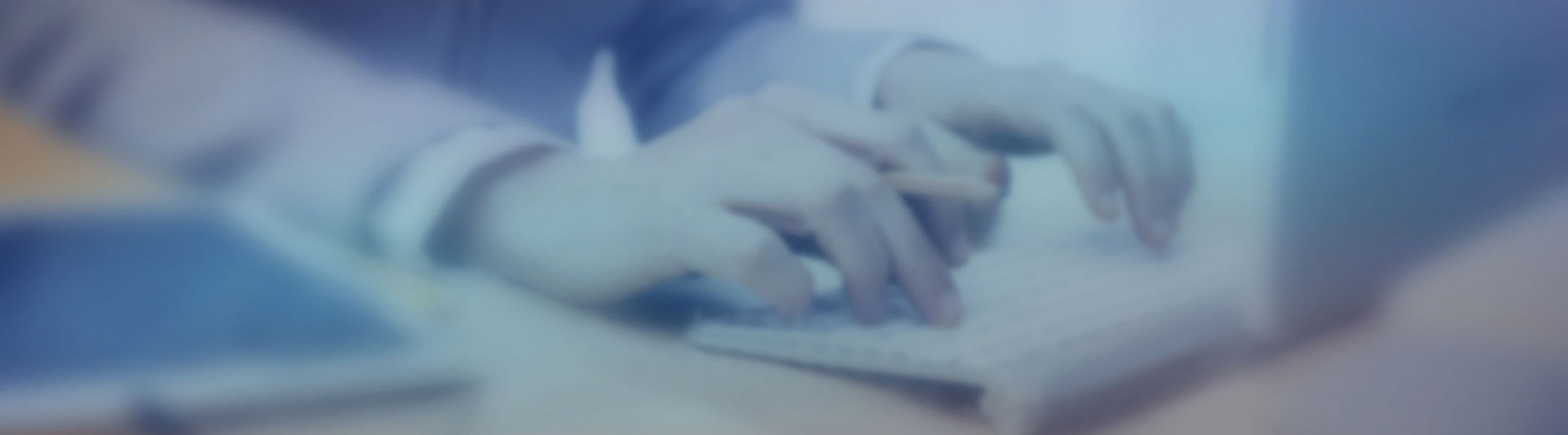 supplier portal_requirements hands on keyboard next to tablet PC