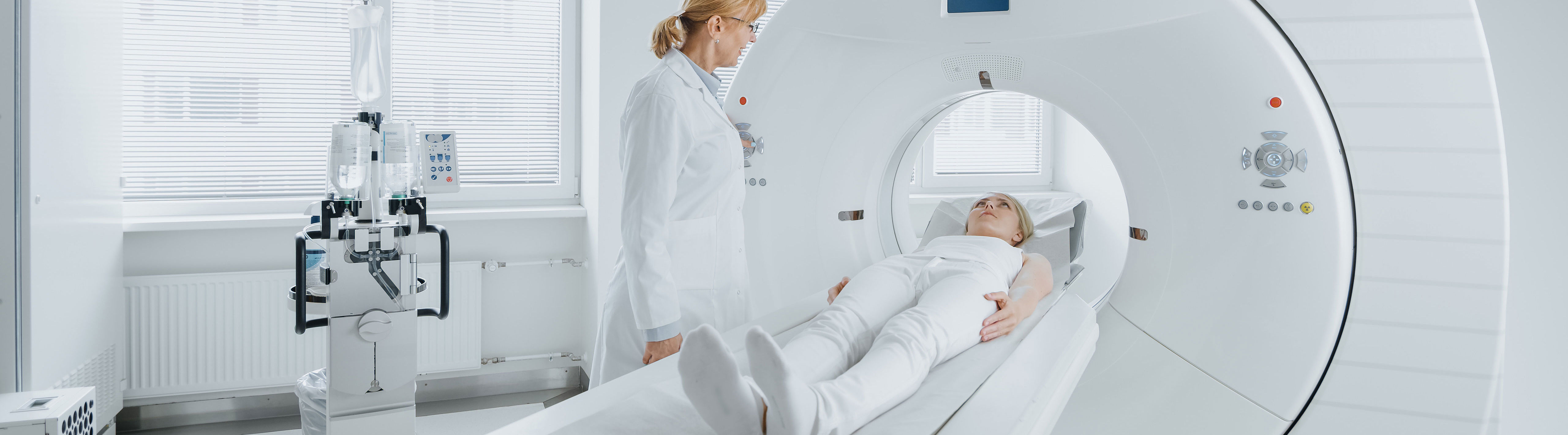 Doctor with woman in computer tomography scanner