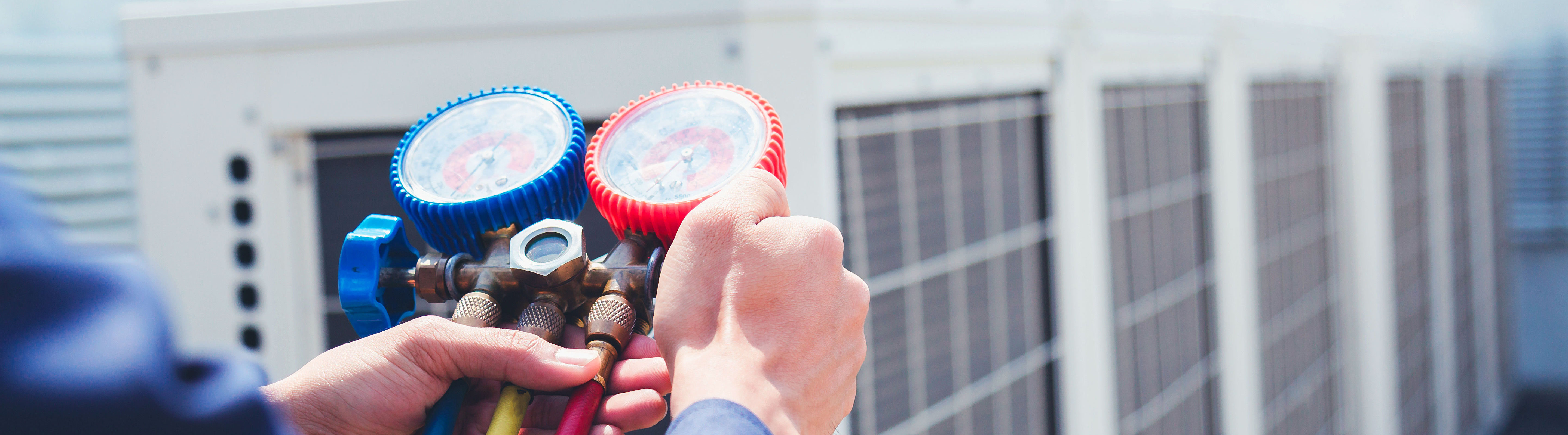 Hand adjusts red and blue valve