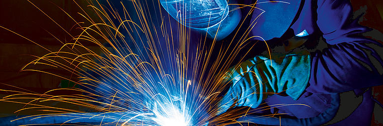 Person in protective clothing during welding