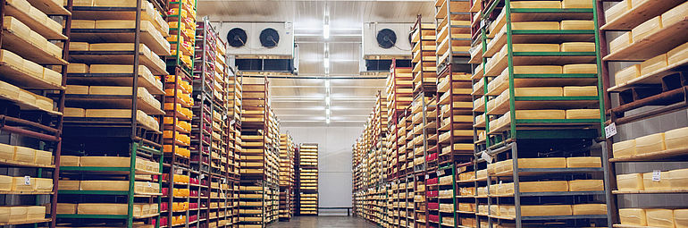 Food stored on shelves with fans in the background