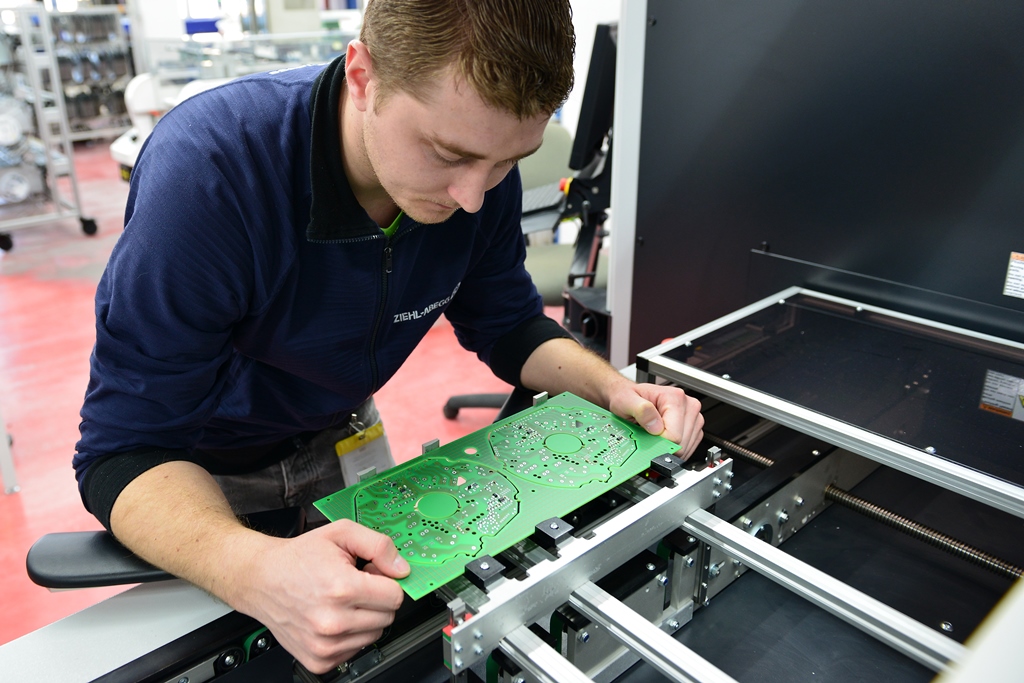 The inspection process in the manufacture of printed circuit boards at Ziehl-Abegg is fully automated but if the machine identifies any anomalies then employees like Vitalij Fofonov check the boards.