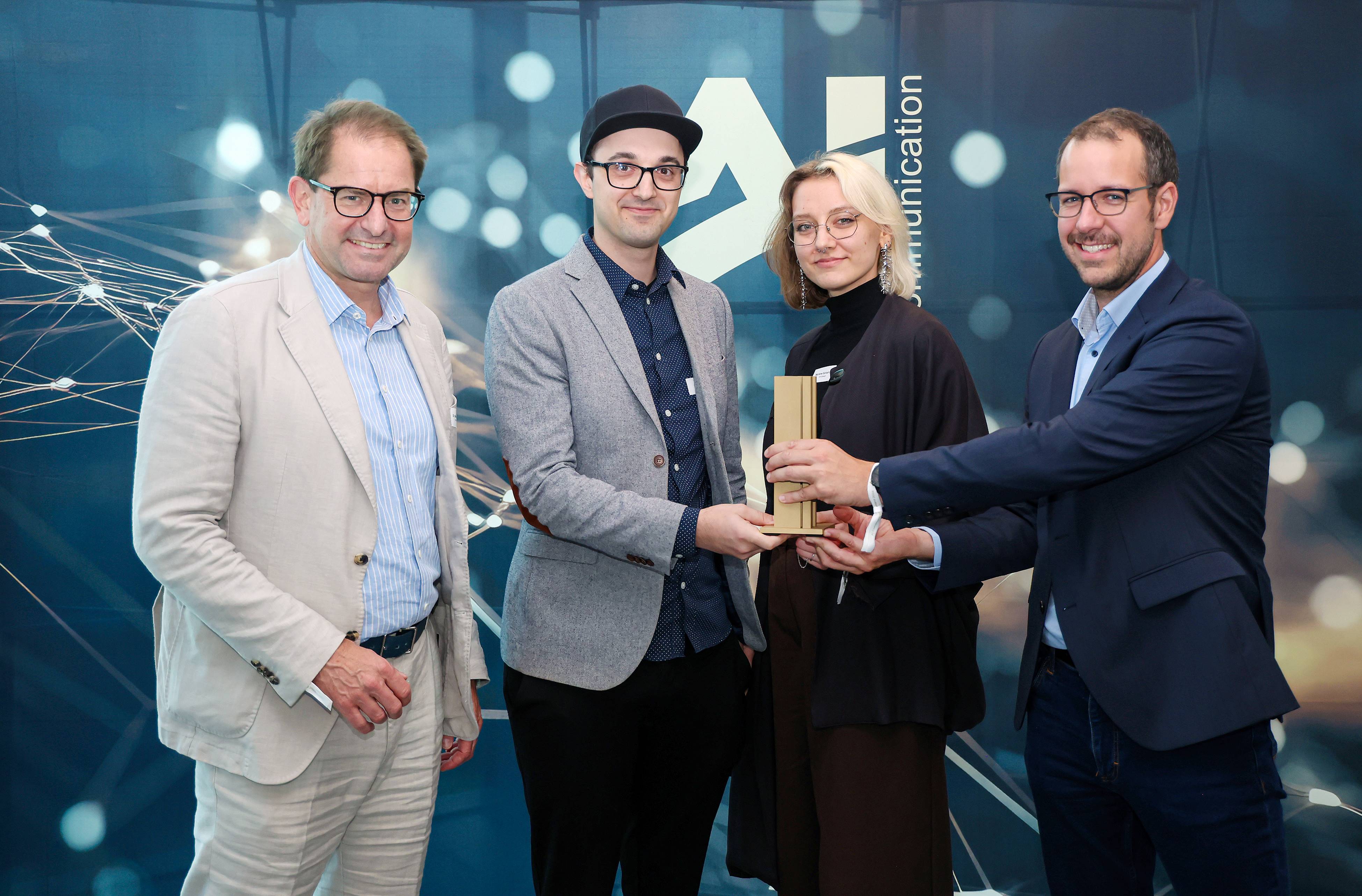 Dr. Marc Wucherer, Kevin May & Marlene Scharlott with the award & Johannes Keller