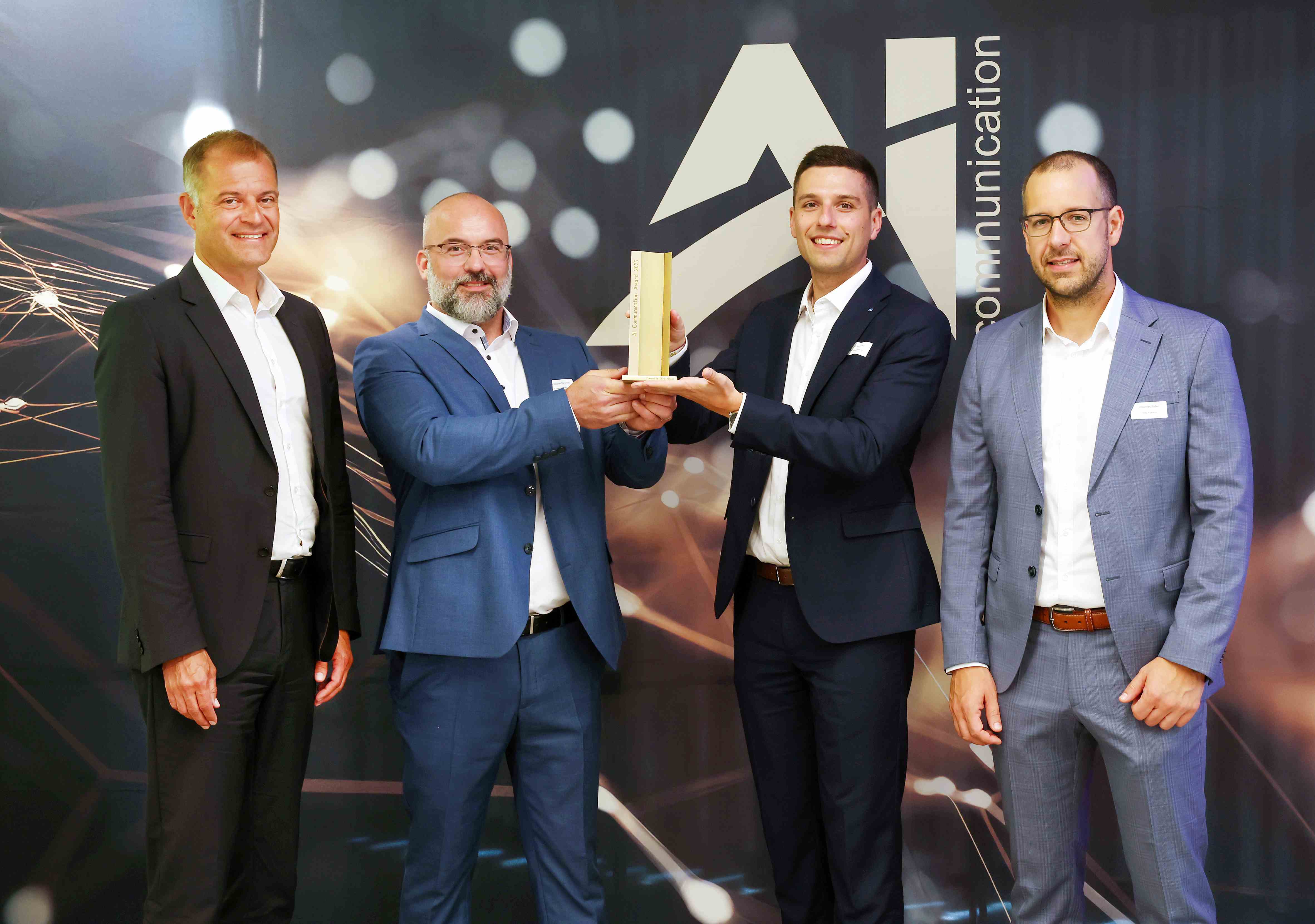 Joachim Ley (CEO of Ziehl-Abegg, left) presents the award with jury chair Johannes Keller (right) to Christopher Rimmele (Head of Communications, Commercial Vehicle Division, second from left) and Johannes Jerg (Spokesperson, ZF Friedrichshafen AG).