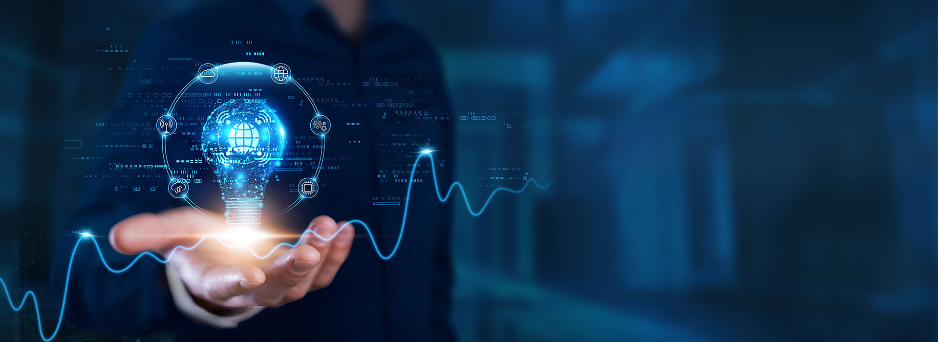 ZIEHL-ABEGG auf der ISH 2025 Eine Hand hält eine digitale Glühbirne mit Digitalfunktionen